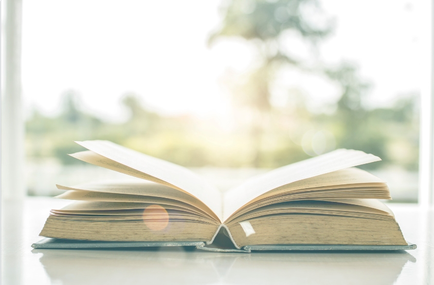 This is an image of an open book on a table.