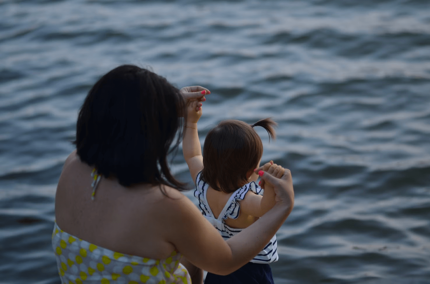 This is an image of a mother and daughter on a beach.