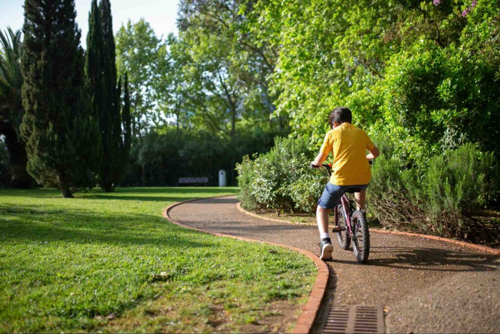 This is a child riding their bike.