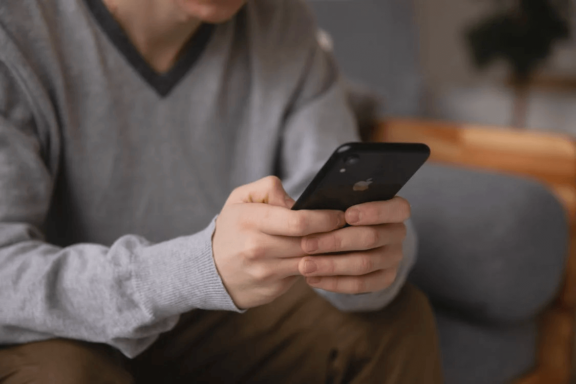 Image of a person holding an iPhone