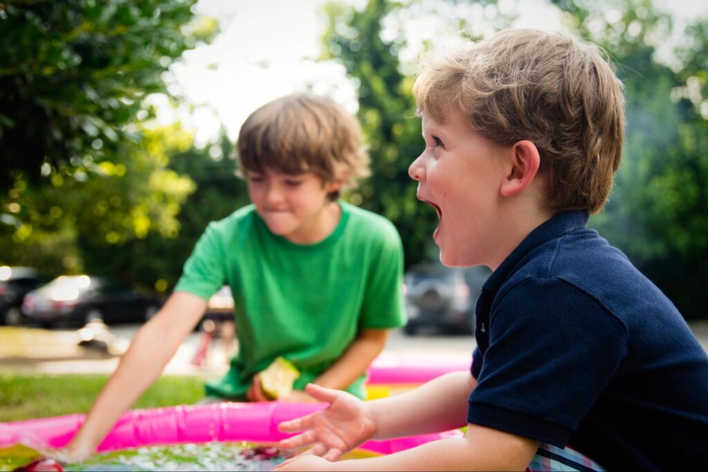 This is an image of two siblings playing together outside.