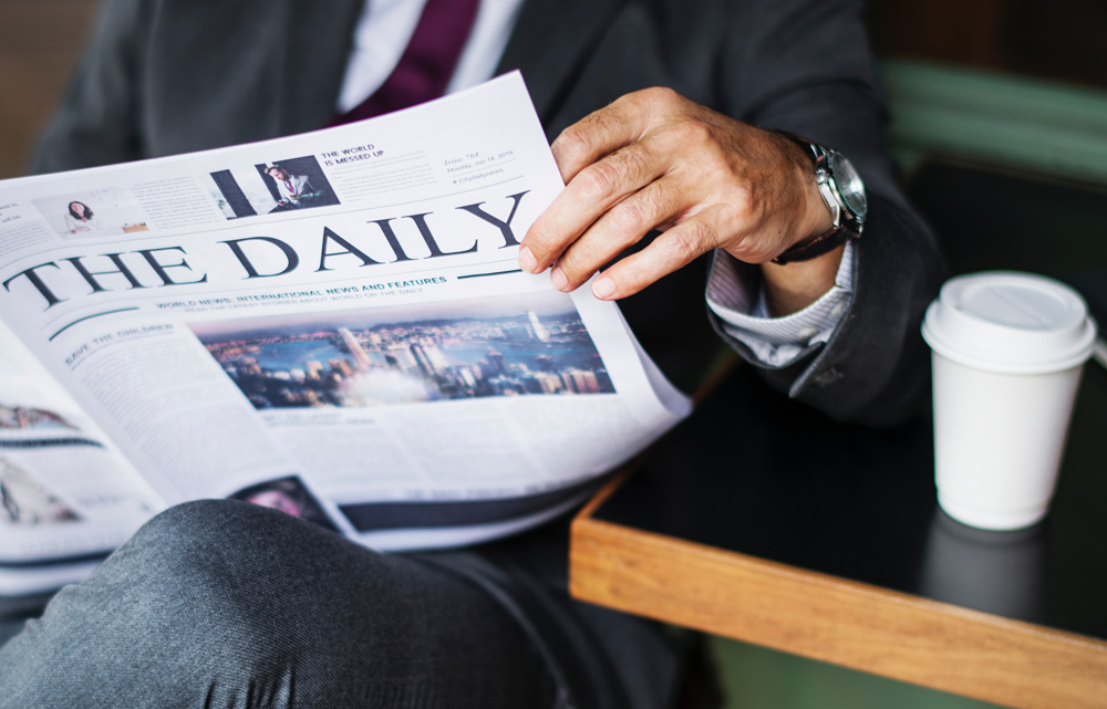 image of a man reading the news
