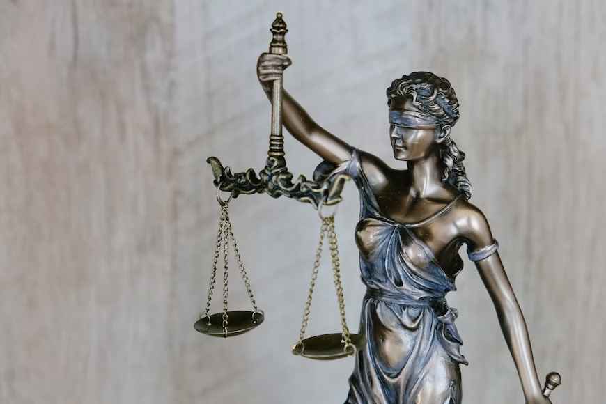 Statue of lady justice with a scale