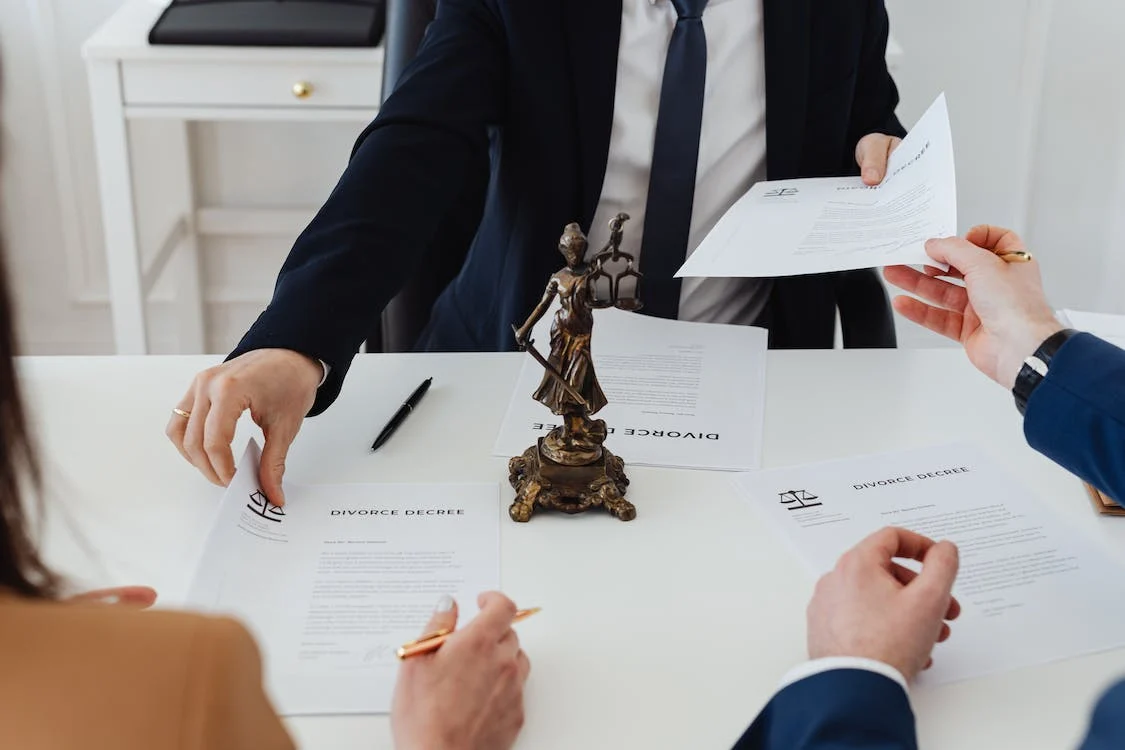 A couple meeting with a judge to sign a divorce decree