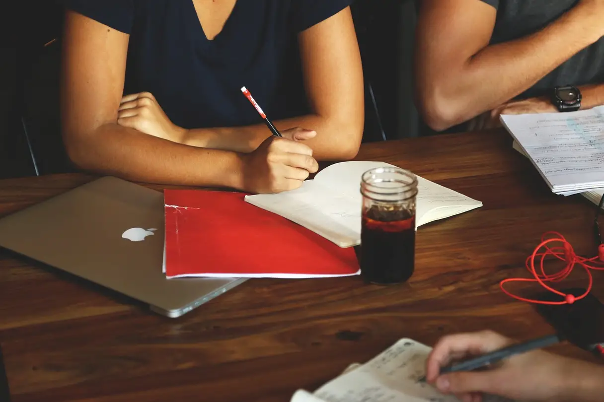 This is a picture of three people sitting at a table.